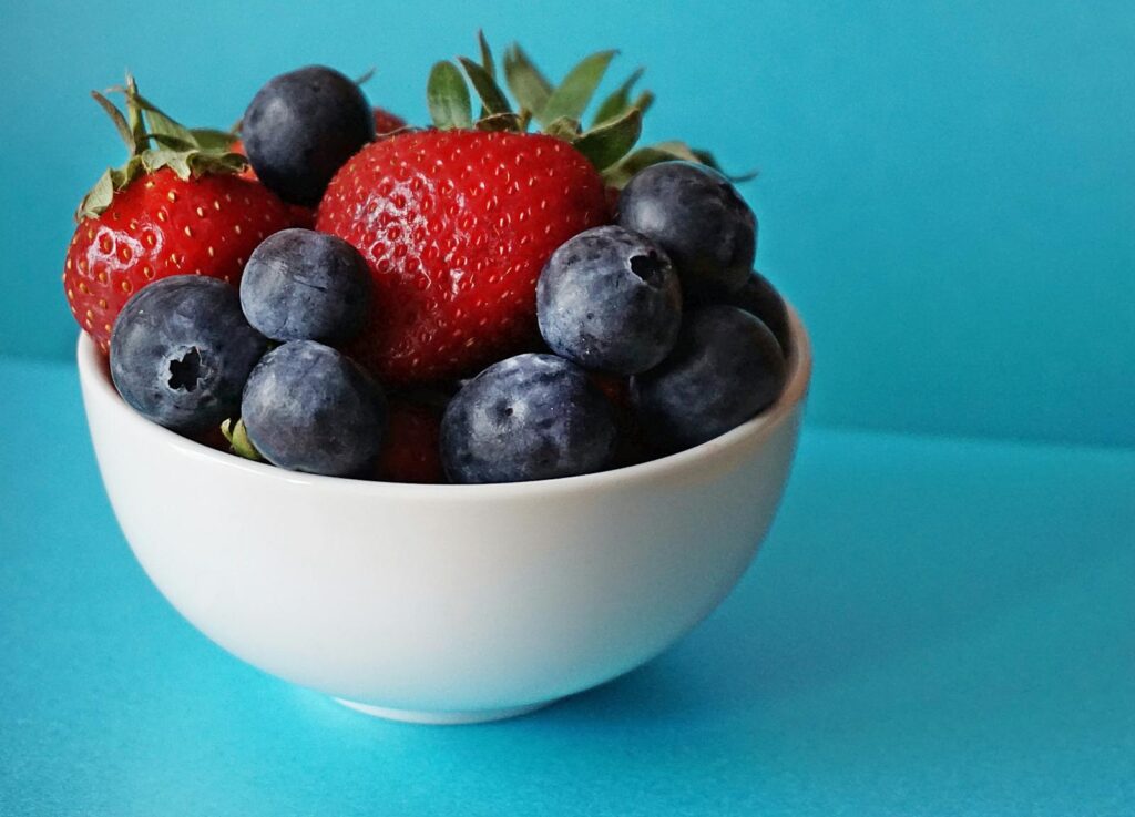 Blueberries and Strawberries in White Ceramic Bowl